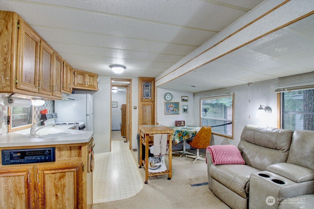 22 Wilderness Way Maple Falls, WA 98266 - Photo 16 of 40 a living room with furniture and a kitchen