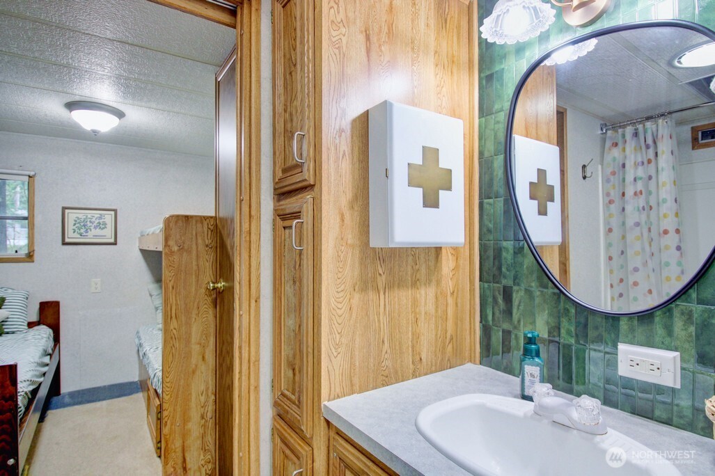 22 Wilderness Way Maple Falls, WA 98266 - Photo 23 of 40 a bathroom with a sink mirror and vanity