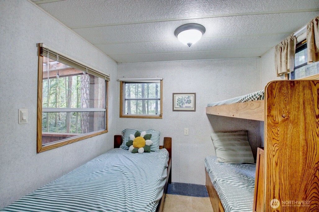 22 Wilderness Way Maple Falls, WA 98266 - Photo 25 of 40 a bedroom with a bed and a window