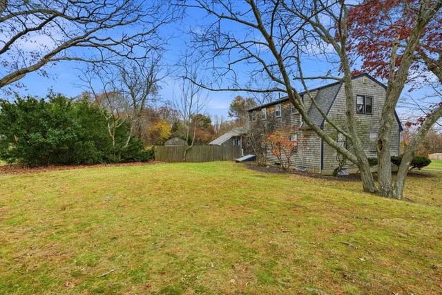 a backyard of a house with large trees