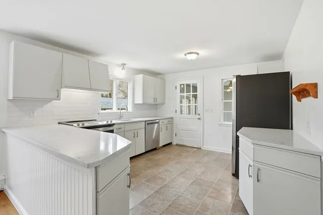 a kitchen with a cabinets and white appliances