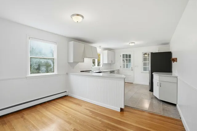 a view of kitchen with microwave and cabinets