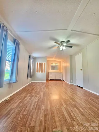 a view of a livingroom with a ceiling fan and window