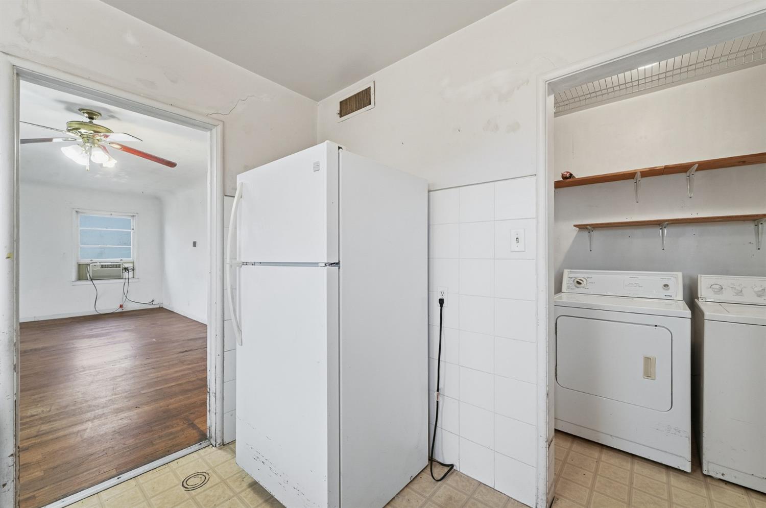 1127 West 19th Street Merced, CA 95340 - Photo 13 of 28 a view of a hallway with closet and wooden floor