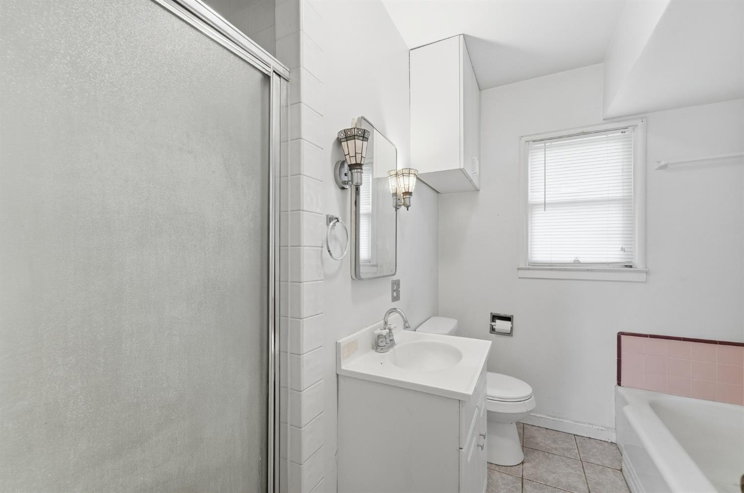 1127 West 19th Street Merced, CA 95340 - Photo 18 of 28 a bathroom with a toilet sink and mirror