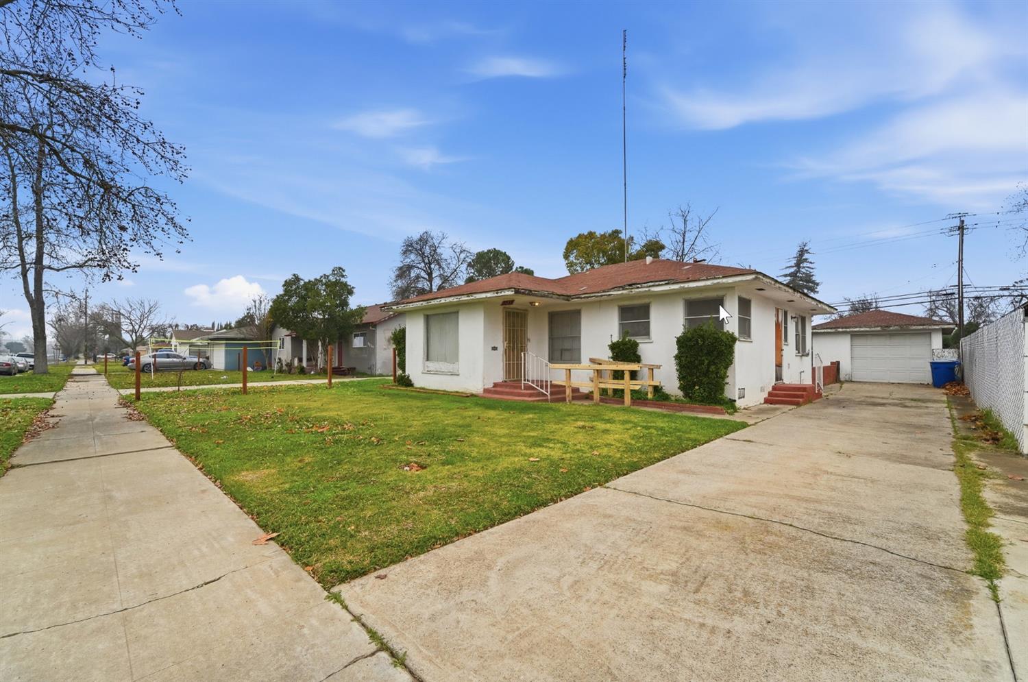 1127 West 19th Street Merced, CA 95340 - Photo 2 of 28 a front view of a house with a yard