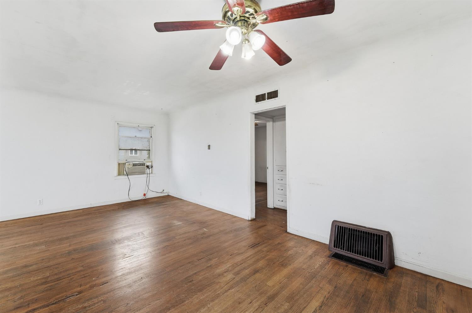 1127 West 19th Street Merced, CA 95340 - Photo 9 of 28 a view of an empty room with wooden floor