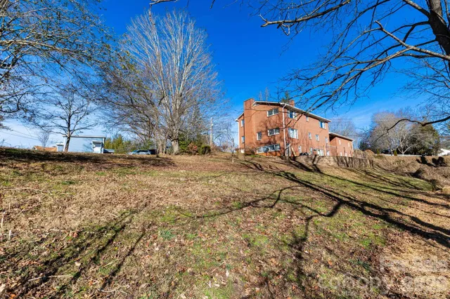 a view of a yard with wooden fence