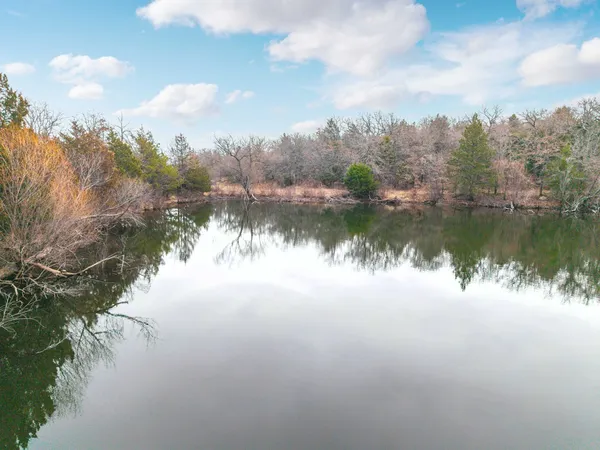 a view of a lake in between two of trees