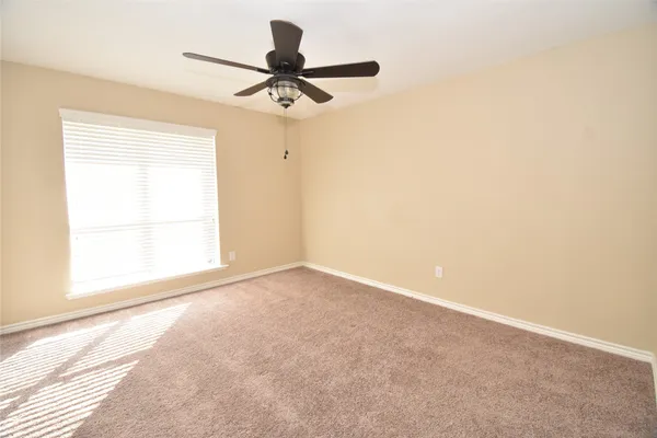 a view of a livingroom with a ceiling fan and window