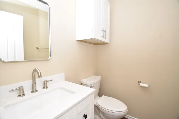 a bathroom with a sink a toilet and mirror