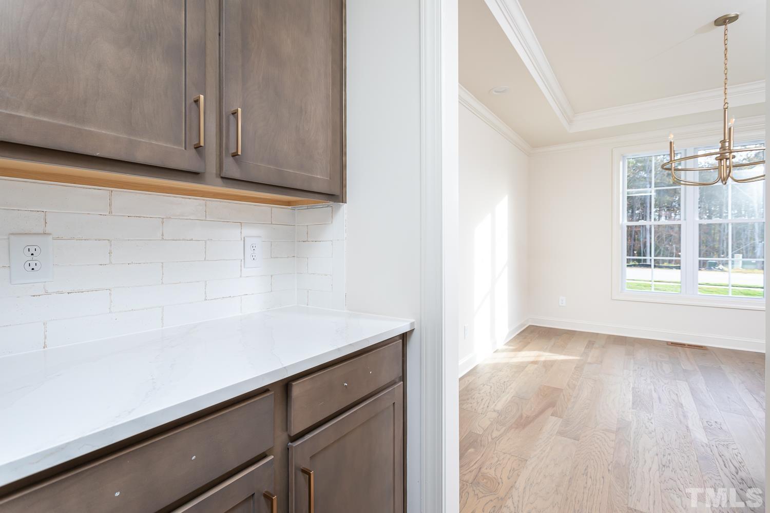 76 Bucchero Lane Clayton, NC 27527 - Photo 12 of 41 a view of a kitchen with wooden floor and cabinets