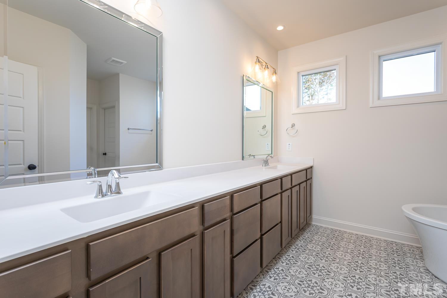76 Bucchero Lane Clayton, NC 27527 - Photo 16 of 41 a bathroom with a sink a toilet and a mirror