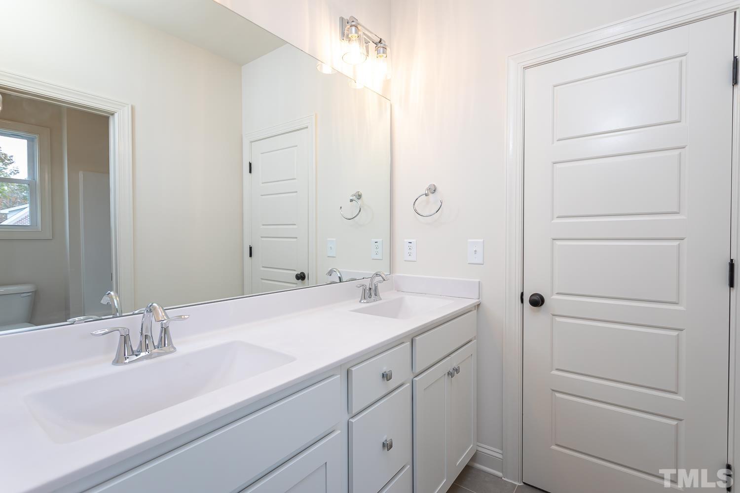 76 Bucchero Lane Clayton, NC 27527 - Photo 25 of 41 a bathroom with a double vanity sink and mirror