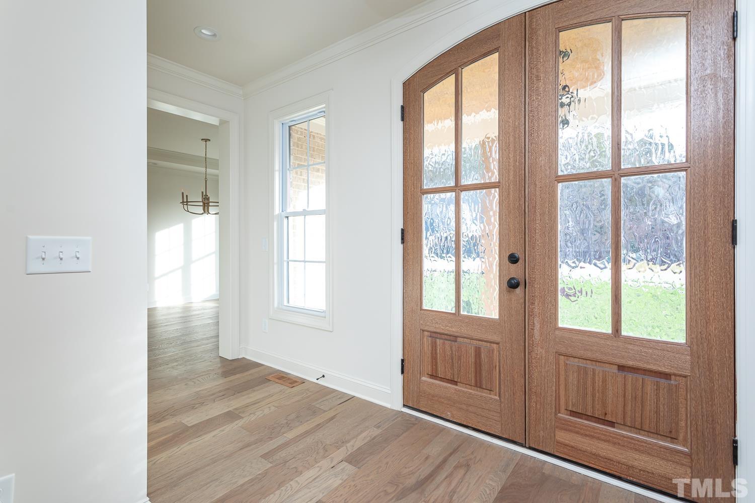 76 Bucchero Lane Clayton, NC 27527 - Photo 4 of 41 a view of an empty room with wooden floor and a window