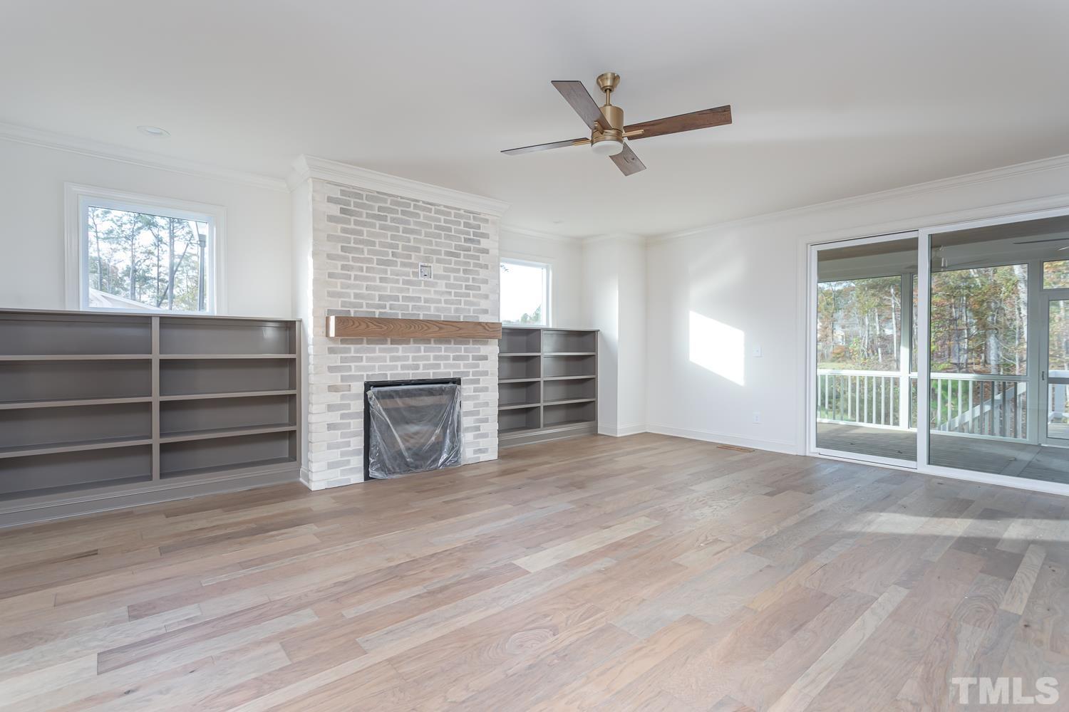 76 Bucchero Lane Clayton, NC 27527 - Photo 10 of 41 a view of an empty room with a window and fireplace