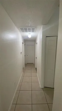 a kitchen with granite countertop a refrigerator and a stove top oven