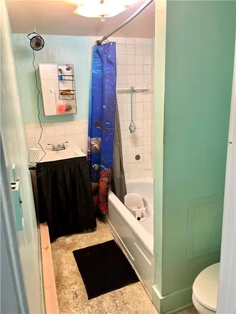 a bedroom with a bed and flat screen tv