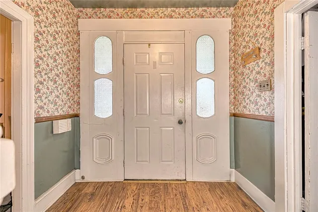 a view of an empty room with cabinet and a window