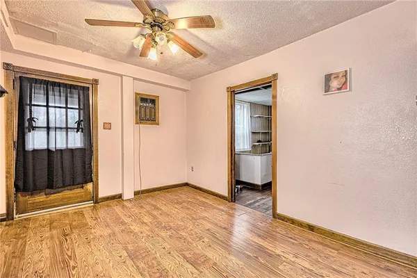 a view of a hallway with wooden floor and dining room