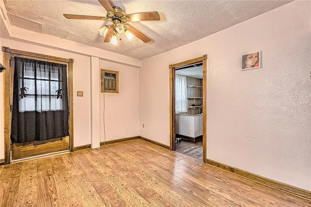 a view of a hallway with wooden floor and dining room