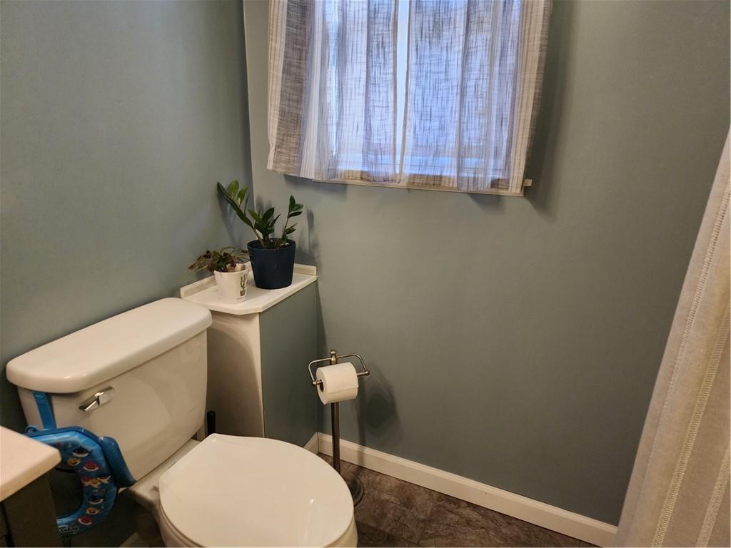 709 North 7th Street Apollo, PA 15613 - Photo 37 of 50 a white toilet sitting next to a wooden cabinet