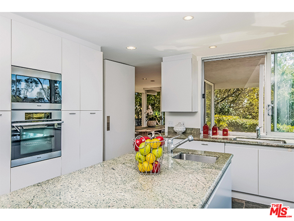 1437 North Tigertail Road Los Angeles, CA 90049 - Photo 11 of 31 a kitchen with stainless steel appliances granite countertop a sink stove and cabinets