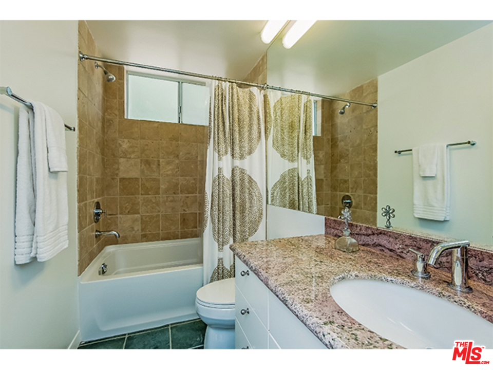 1437 North Tigertail Road Los Angeles, CA 90049 - Photo 14 of 31 a bathroom with a granite countertop sink toilet and shower