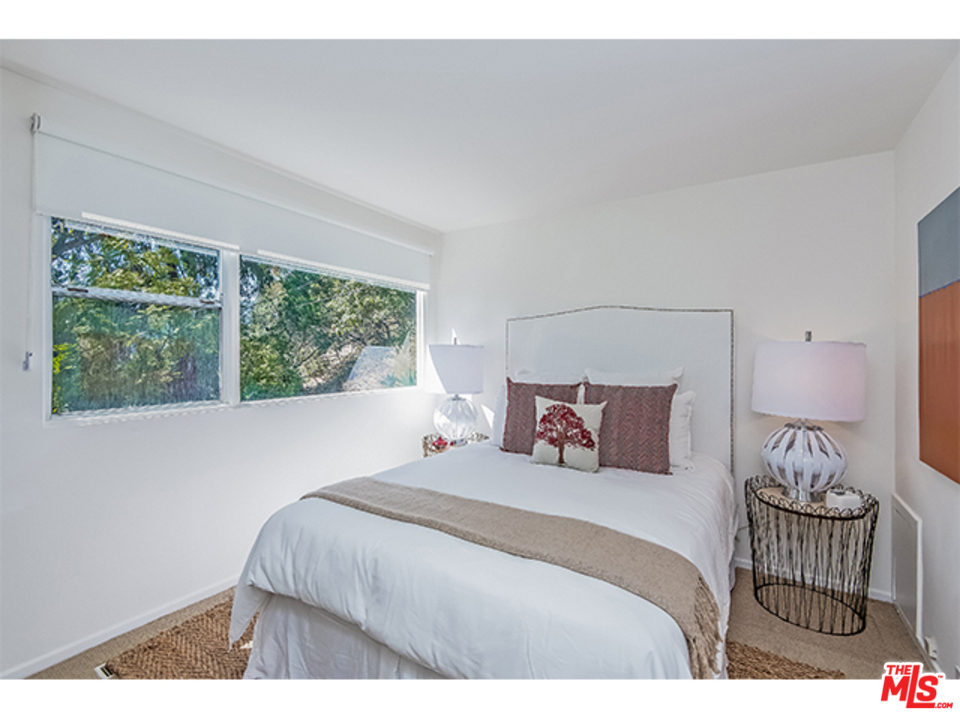 1437 North Tigertail Road Los Angeles, CA 90049 - Photo 17 of 31 a bedroom with a bed and a window