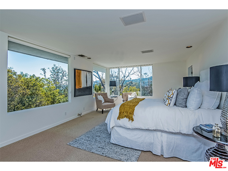1437 North Tigertail Road Los Angeles, CA 90049 - Photo 20 of 31 a bedroom with a large bed and a large window