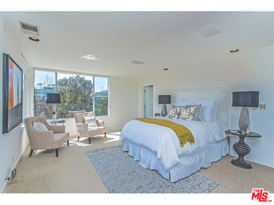 1437 North Tigertail Road Los Angeles, CA 90049 - Photo 21 of 31 a bedroom with a bed and large windows