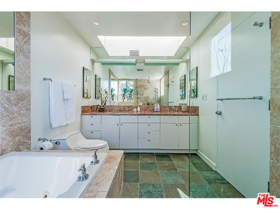 1437 North Tigertail Road Los Angeles, CA 90049 - Photo 24 of 31 a bathroom with a sink mirror and a shower