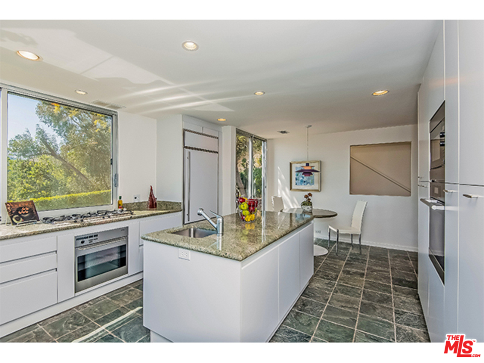 1437 North Tigertail Road Los Angeles, CA 90049 - Photo 9 of 31 a living room with stainless steel appliances kitchen island granite countertop a sink and cabinets