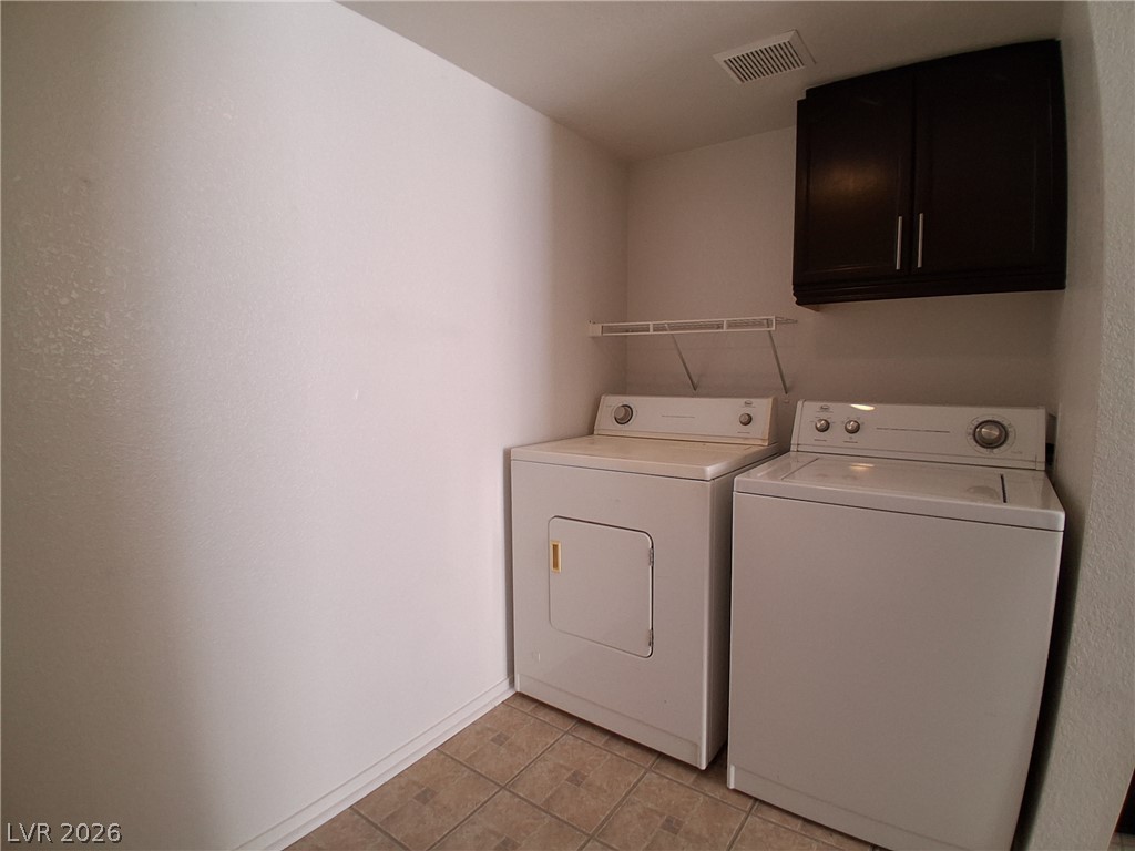 8023 Simone Avenue Las Vegas, NV 89147 - Photo 6 of 12 Functional utility space with tile flooring, offering practical laundry solutions.