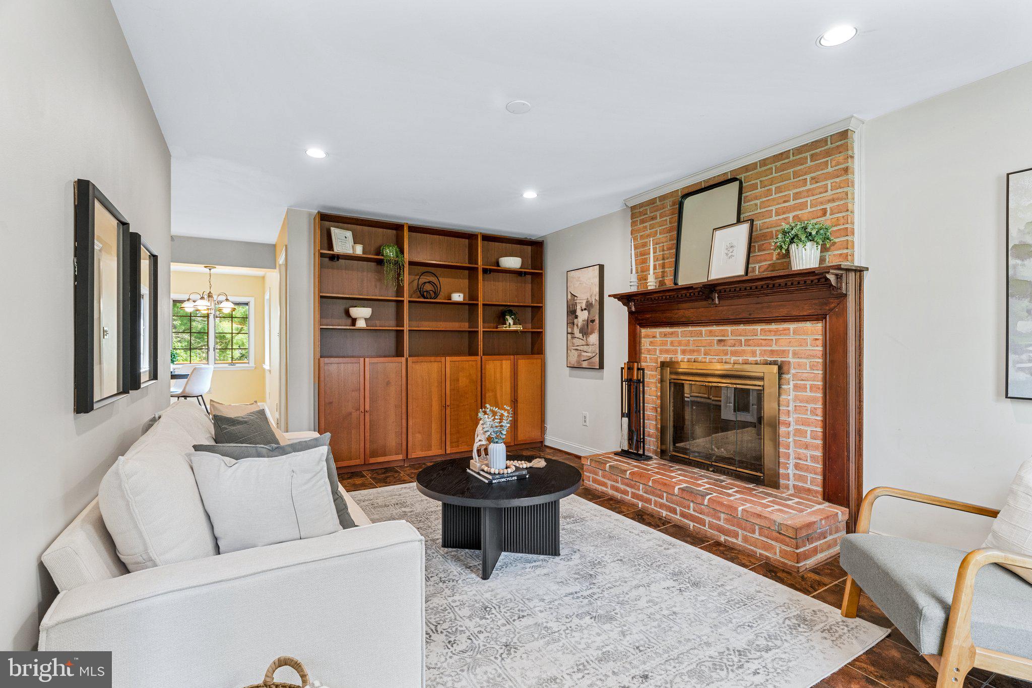 12400 Triple Crown Road Gaithersburg, MD 20878 - Photo 5 of 45 Family Room with Shelving and Fireplace