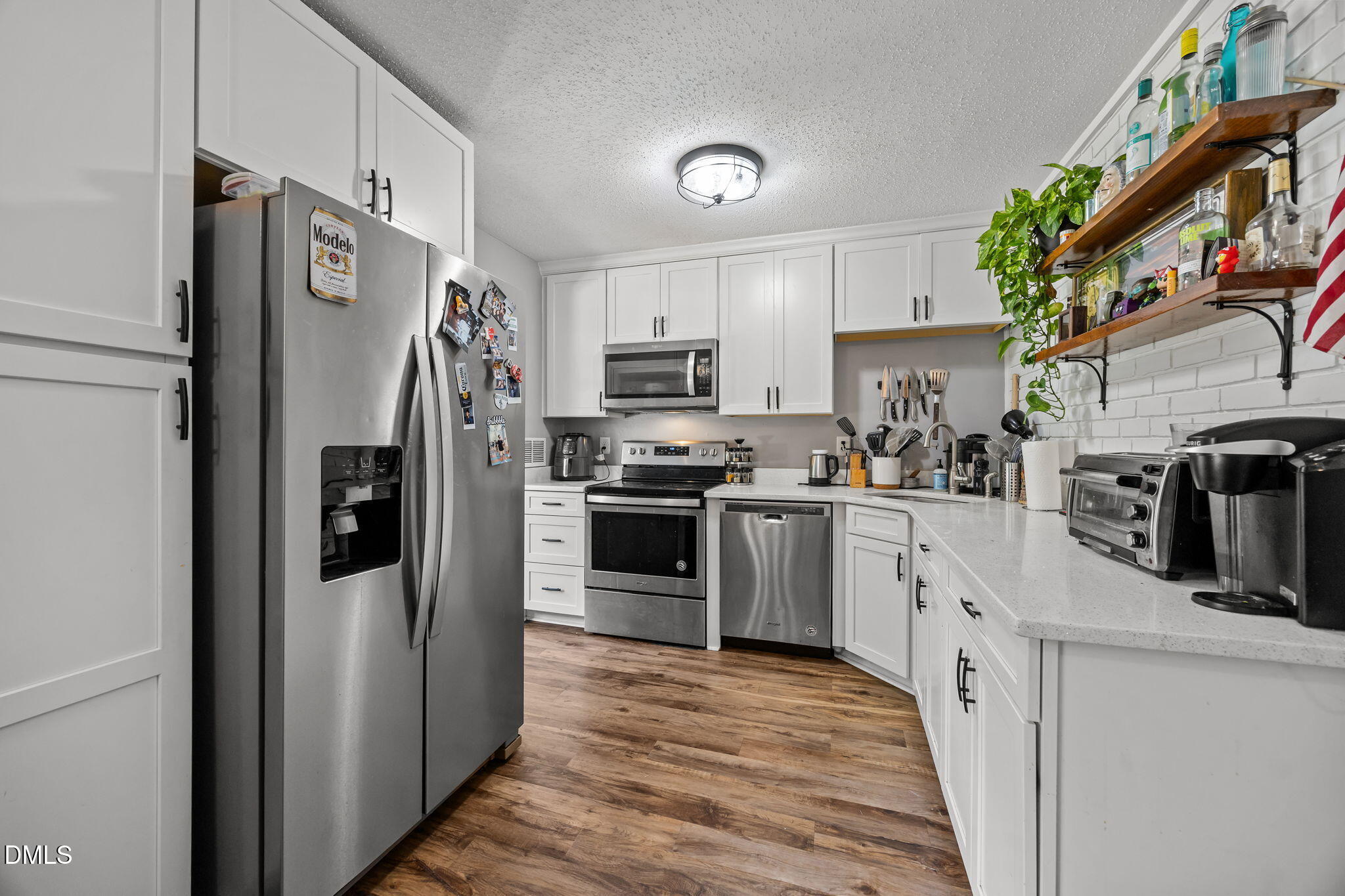 3418 Avent Ferry Road Raleigh, NC 27606 - Photo 3 of 25 a kitchen with stainless steel appliances and refrigerator