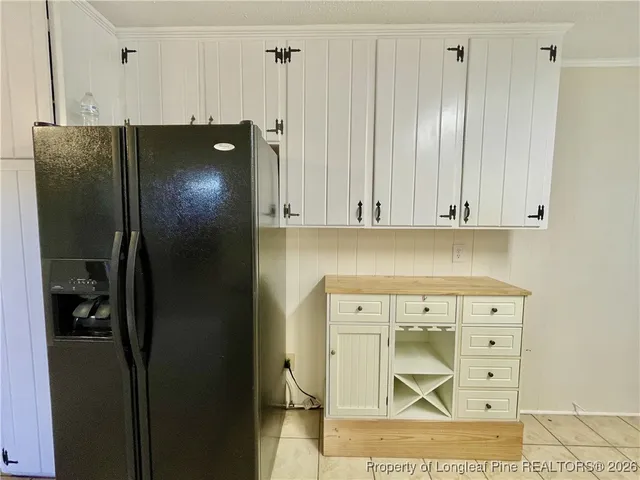 a kitchen with a refrigerator and cabinets