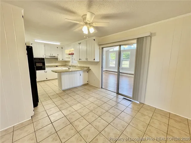 a large kitchen with a sink and cabinets