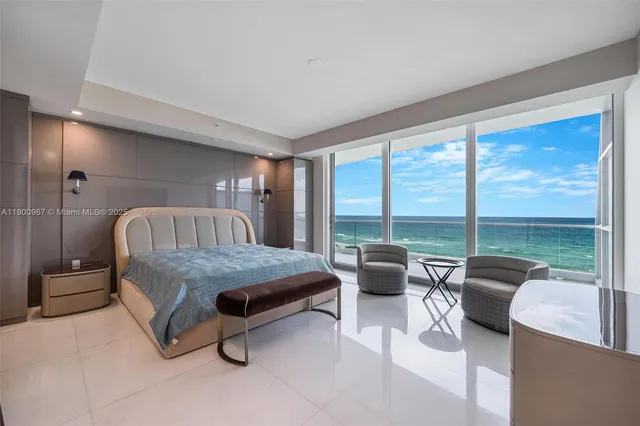 a living room with furniture and a floor to ceiling window