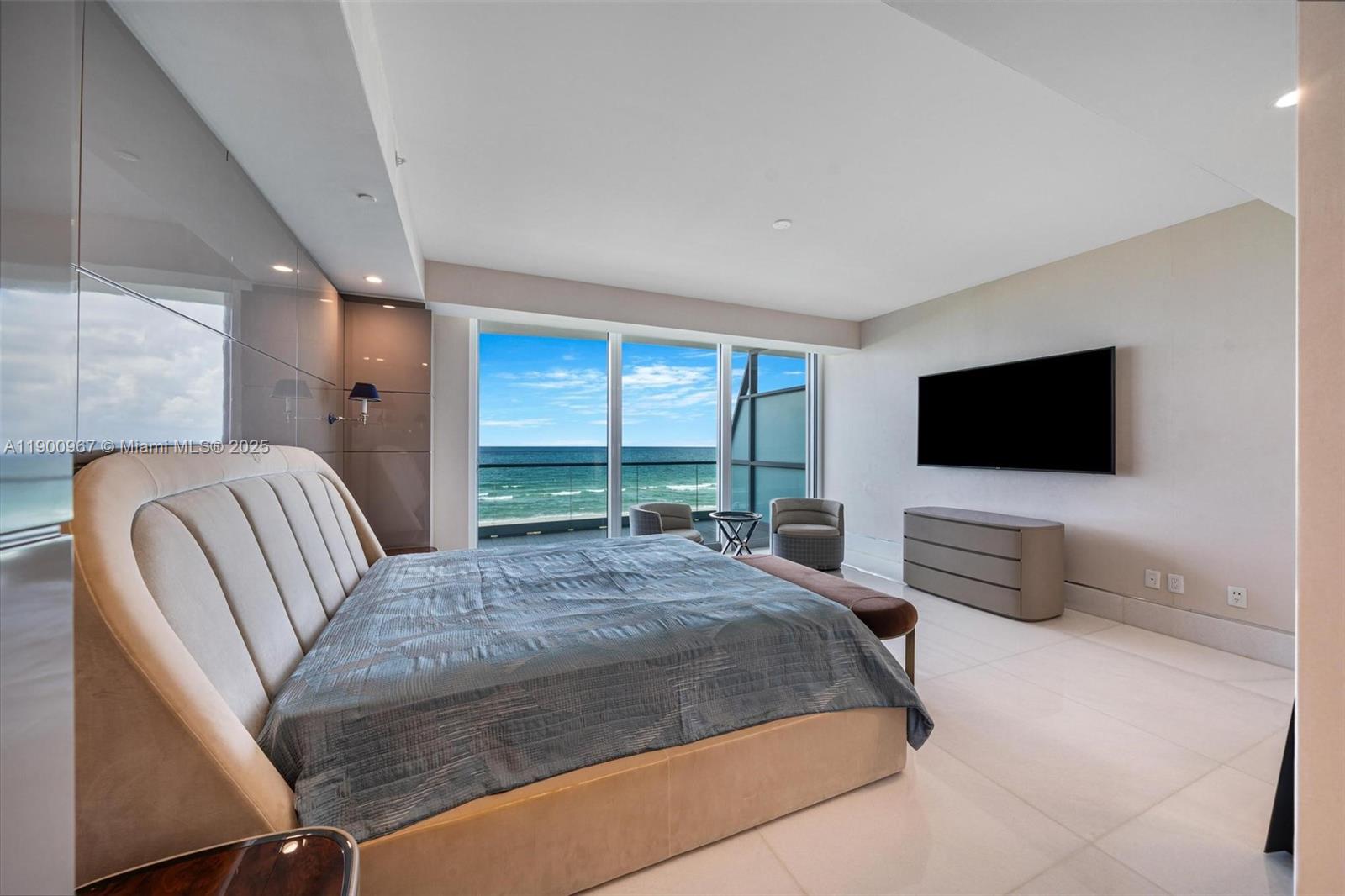 9349 Collins Avenue, Unit 503 Surfside, FL 33154 - Photo 14 of 30 a bedroom with a bed and a flat screen tv