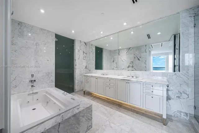 a bathroom with a bathtub sink and mirror