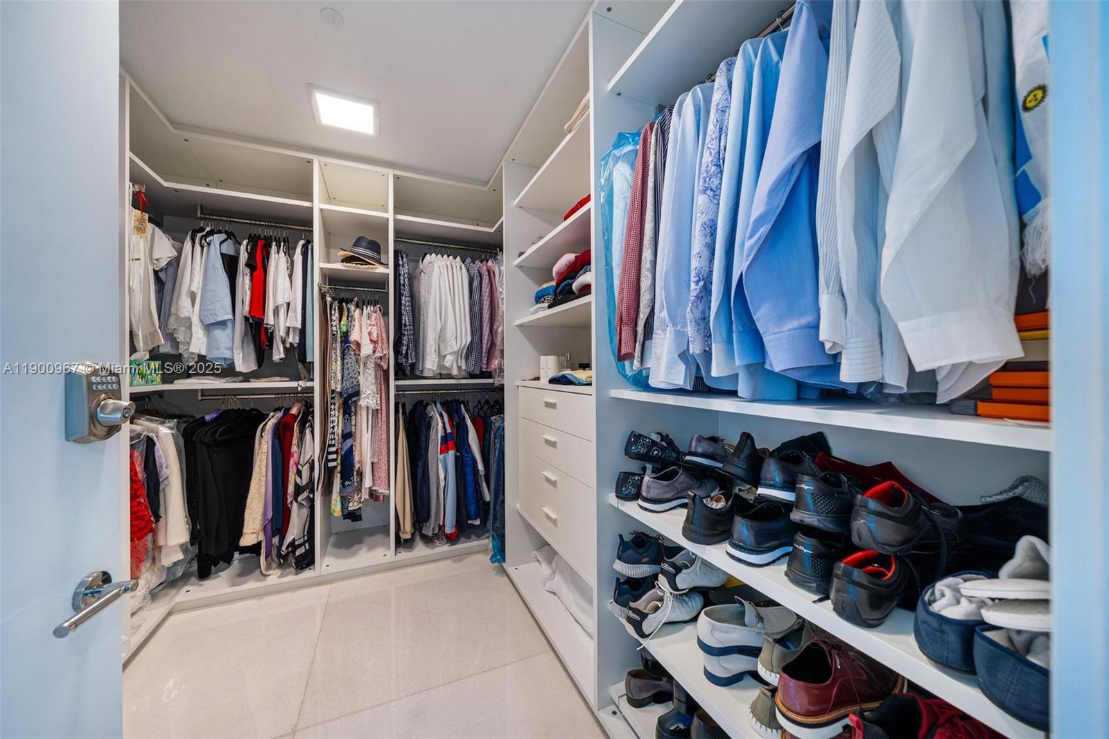 9349 Collins Avenue, Unit 503 Surfside, FL 33154 - Photo 17 of 30 a view of walk in closet with clothes and shoes
