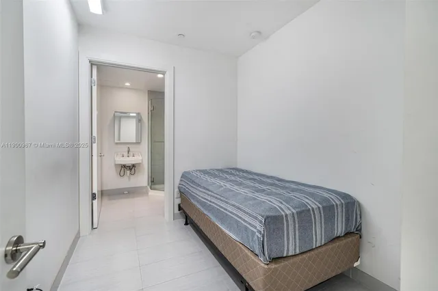 a room with a bed and mirror