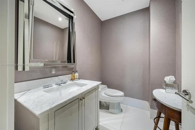 a bathroom with a sink toilet and mirror