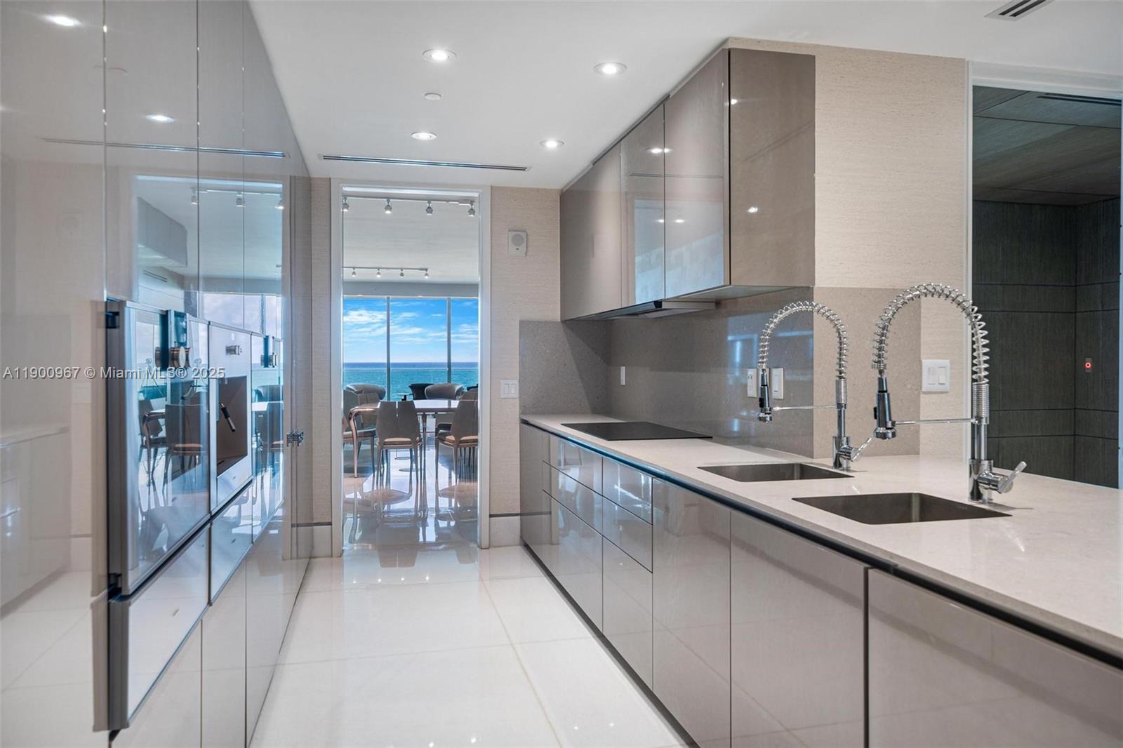 9349 Collins Avenue, Unit 503 Surfside, FL 33154 - Photo 9 of 30 a kitchen with stainless steel appliances granite countertop a sink and cabinets
