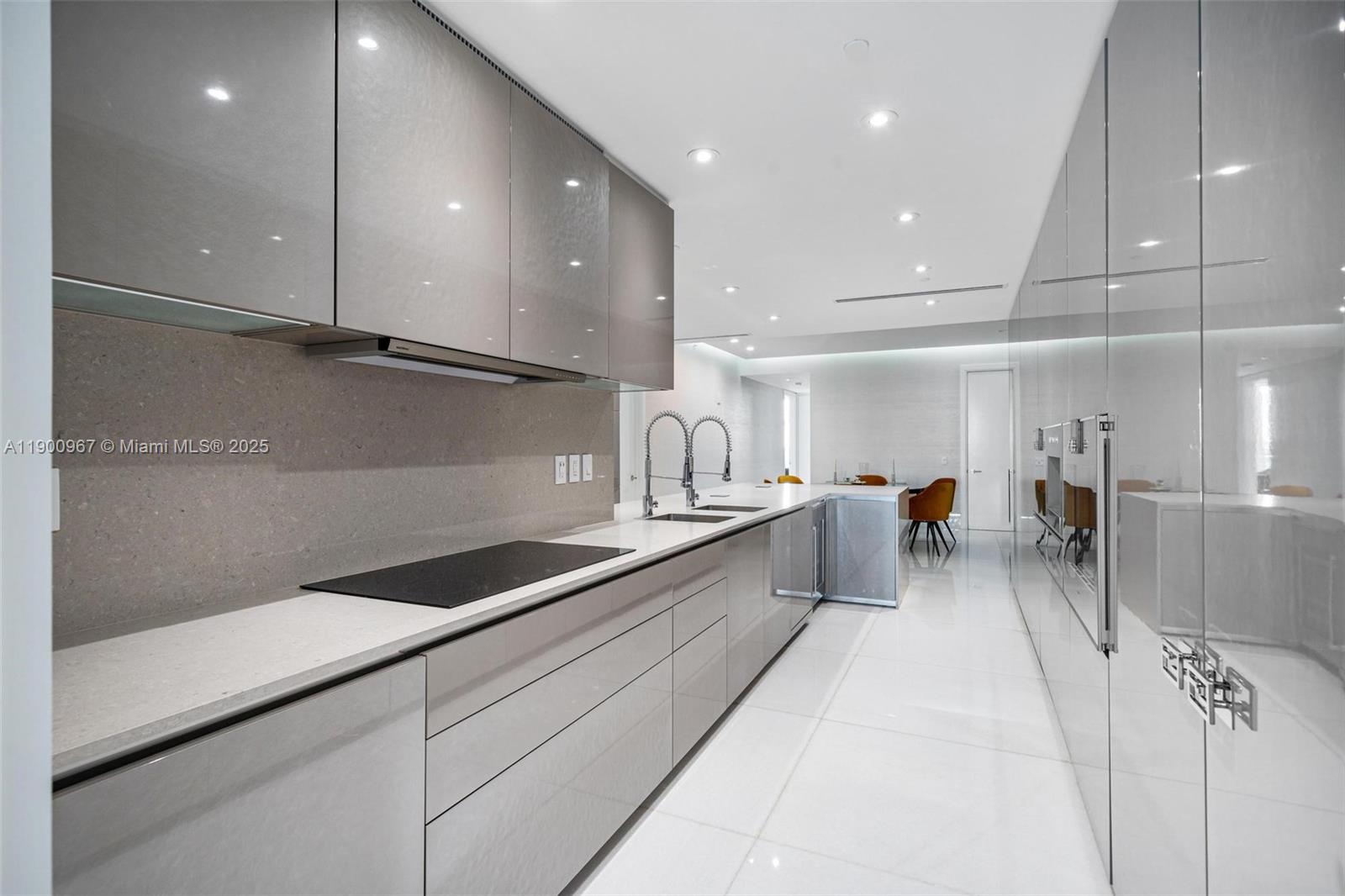 9349 Collins Avenue, Unit 503 Surfside, FL 33154 - Photo 10 of 30 a kitchen with counter top space cabinets and stainless steel appliances