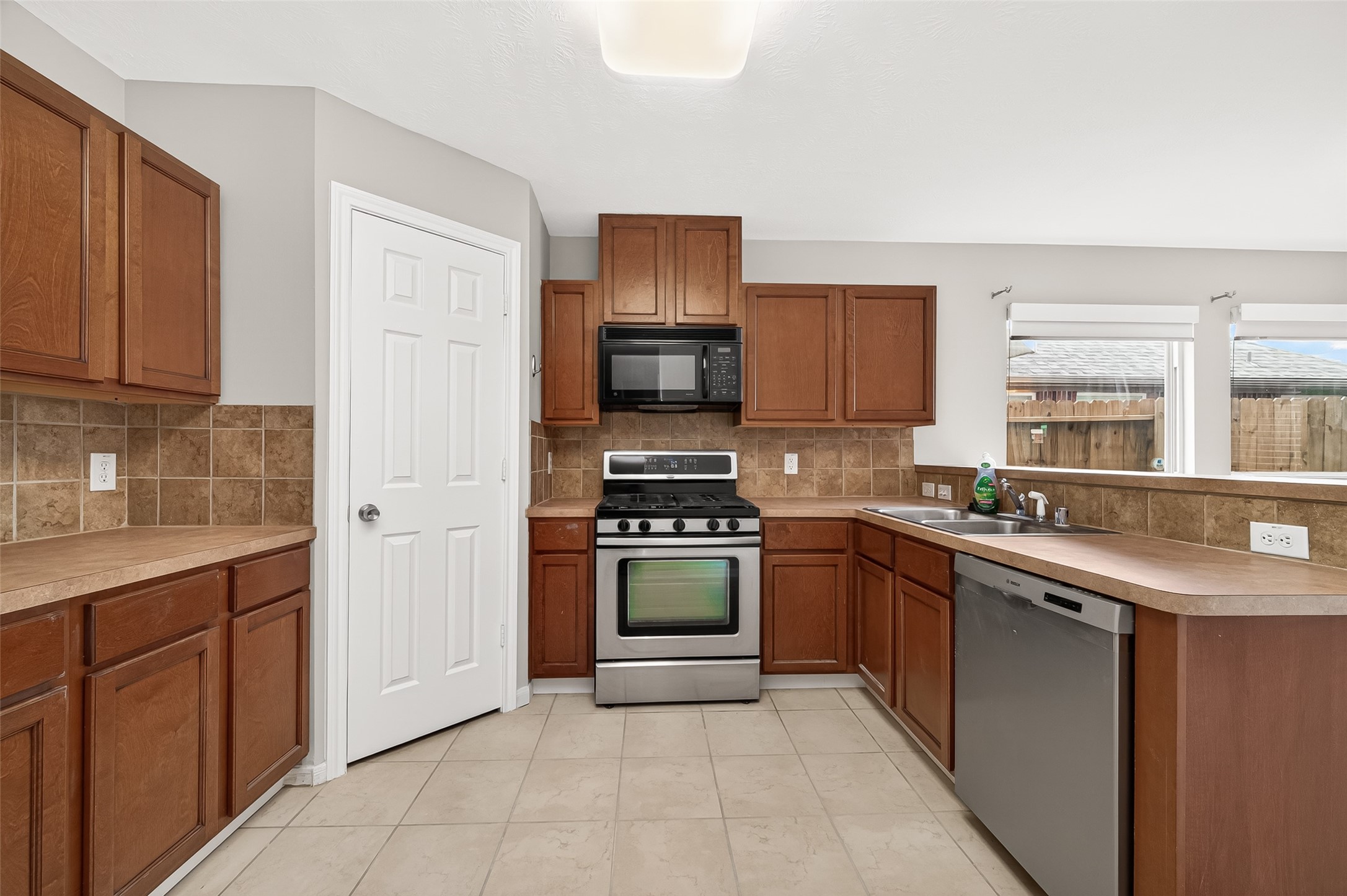 2415 Lacyberry Street Houston, TX 77080 - Photo 11 of 50 a kitchen with stainless steel appliances granite countertop a stove top oven a sink and dishwasher