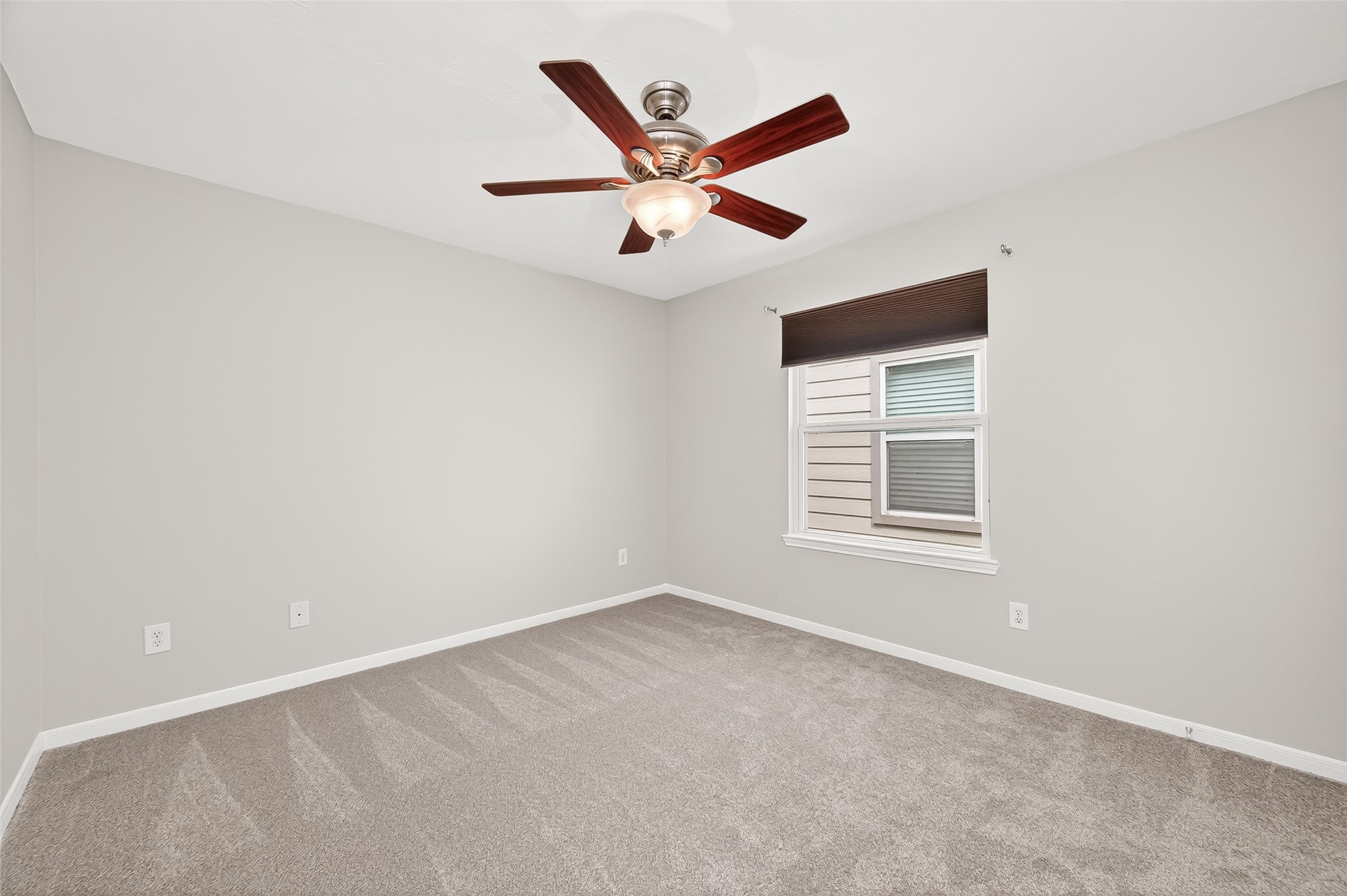 2415 Lacyberry Street Houston, TX 77080 - Photo 26 of 50 an empty room with ceiling fan and window
