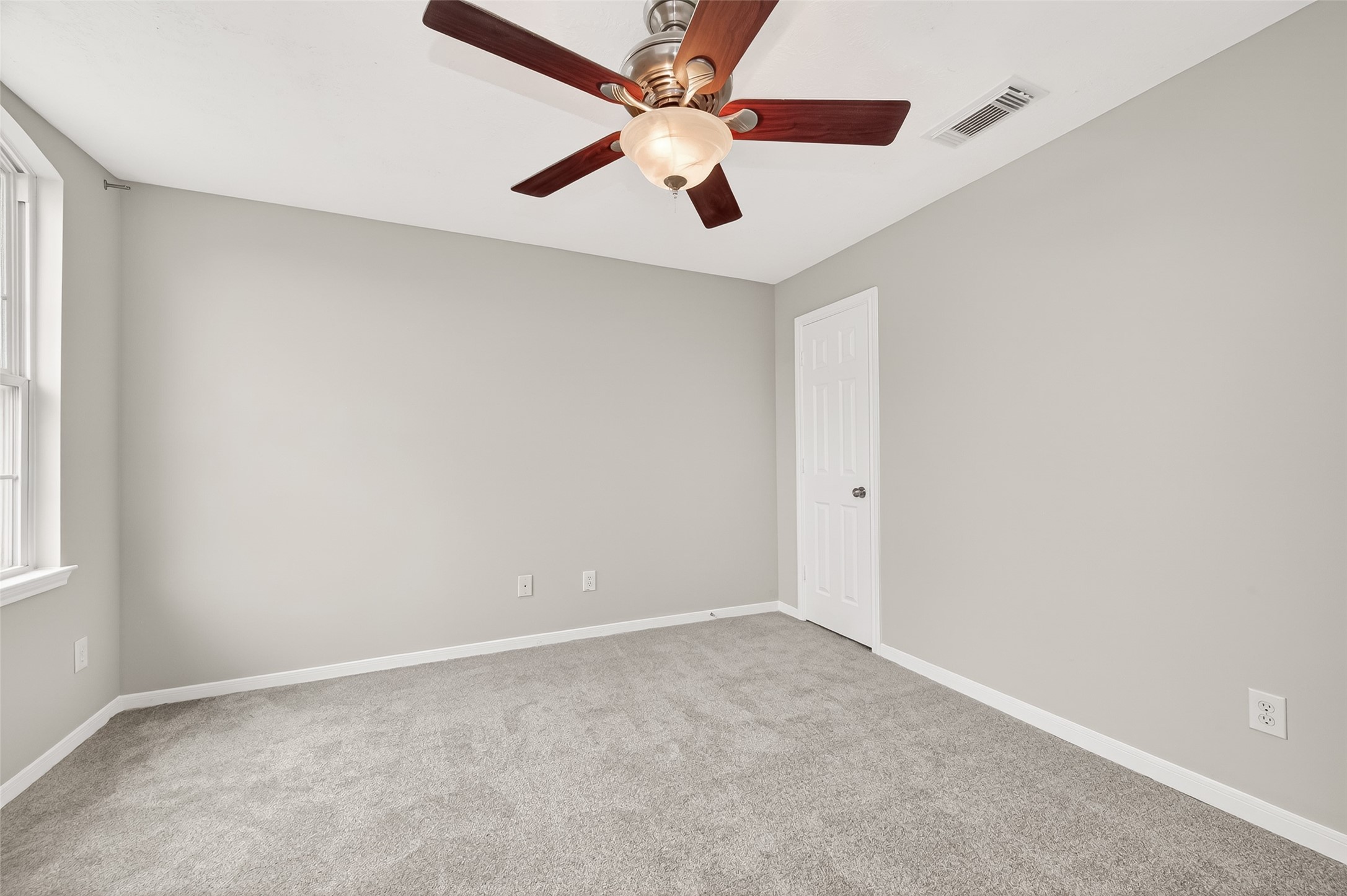 2415 Lacyberry Street Houston, TX 77080 - Photo 31 of 50 an empty room with a window and a fan