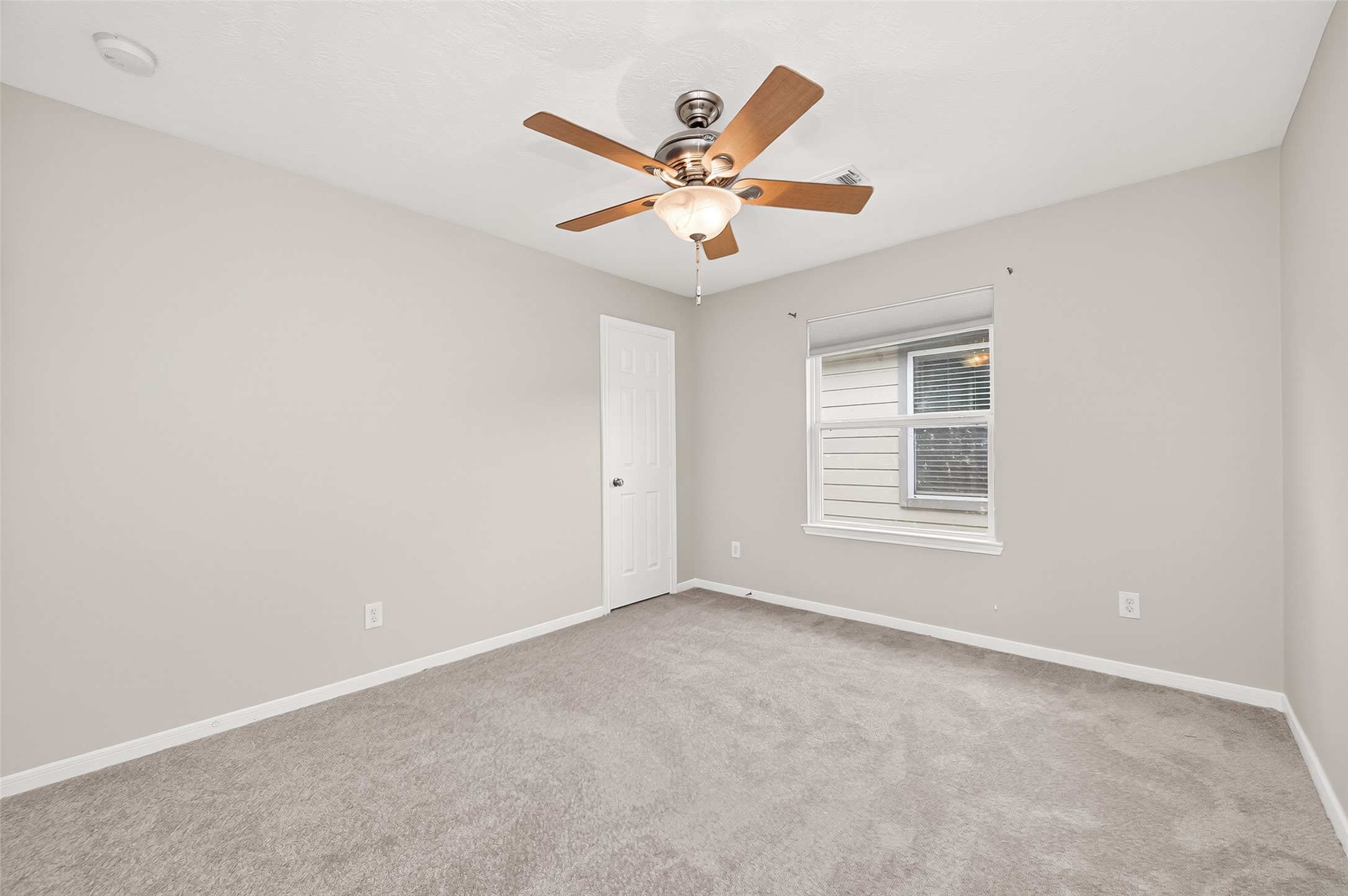 2415 Lacyberry Street Houston, TX 77080 - Photo 36 of 50 a view of a livingroom with a ceiling fan and window